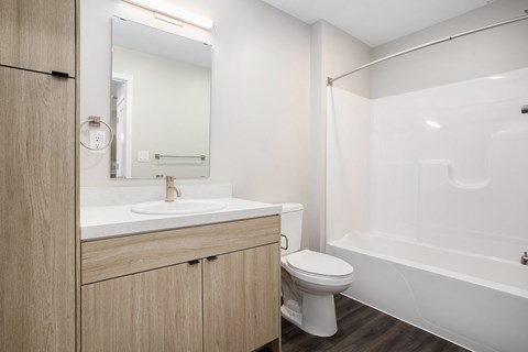 A white toilet sits next to a sink in a modern bathroom.