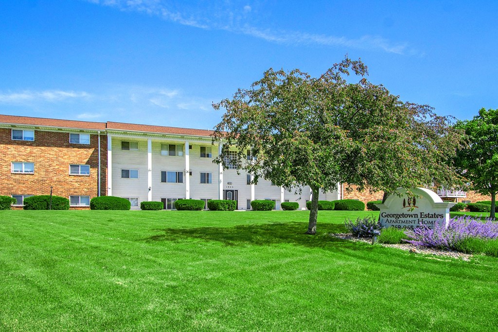 a large brick building with a tree in front of it