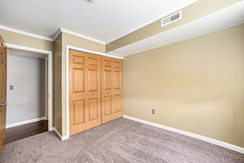 a bedroom with a closet and a door that is open