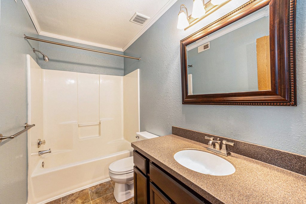 a bathroom with a toilet sink and shower