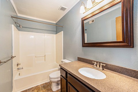 a bathroom with a toilet sink and shower