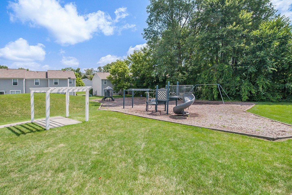 a park with a playground and a swing set