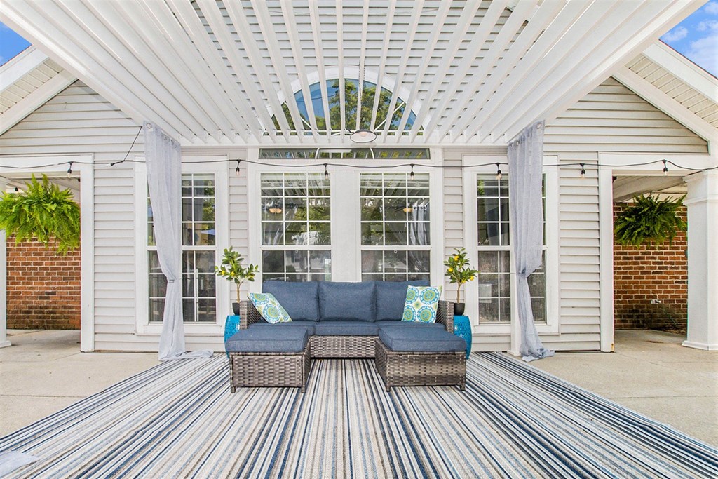 a living area with a couch and a table on a patio