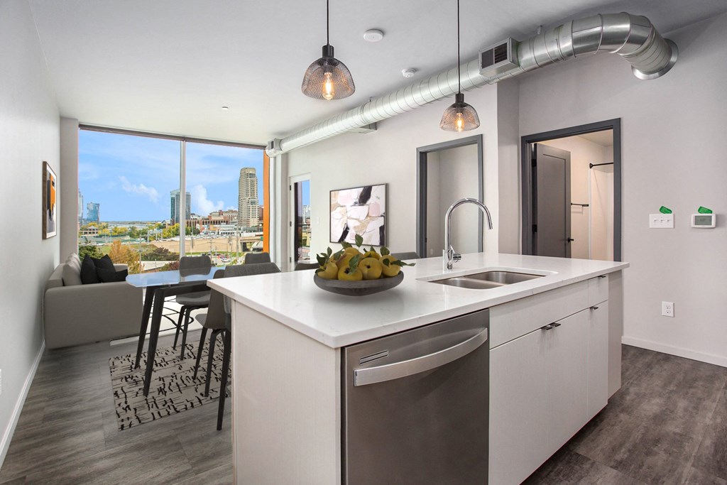an open kitchen and living room with a view of the city