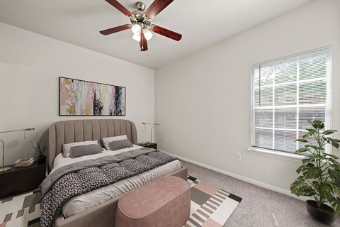 a bedroom with a bed and a ceiling fan