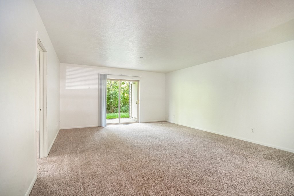 a bedroom with white walls and carpet