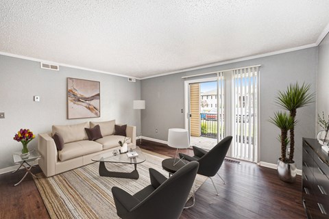 a living room with a couch and a table and chairs