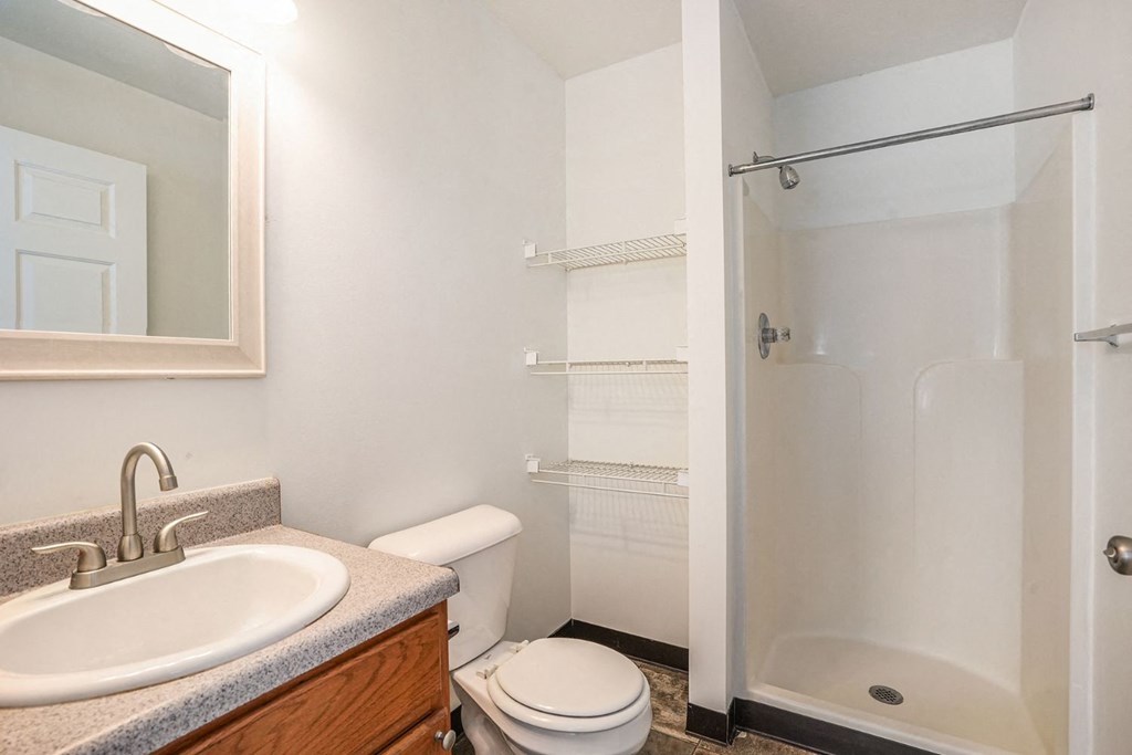 a bathroom with a toilet sink and shower