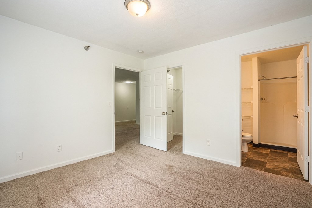 a bedroom with a closet and a toilet