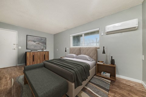 a bedroom with a bed and a couch