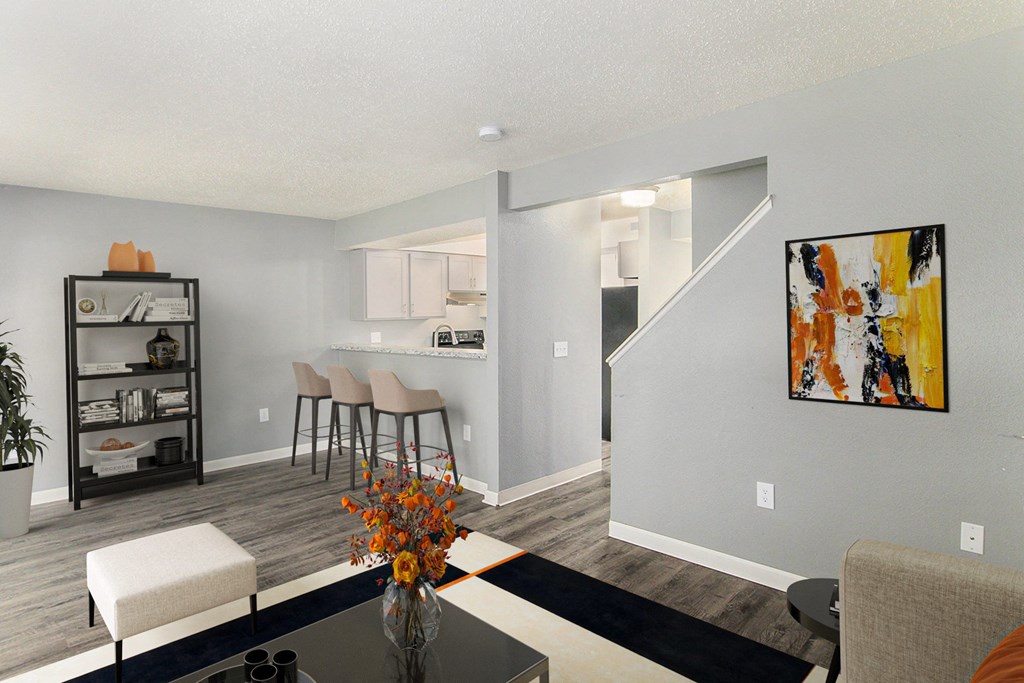 a living room with a table and chairs and a kitchen