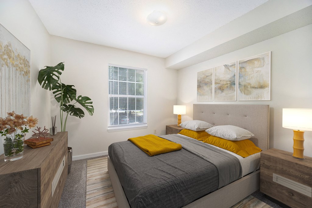 a bedroom with a bed and a dresser and a window