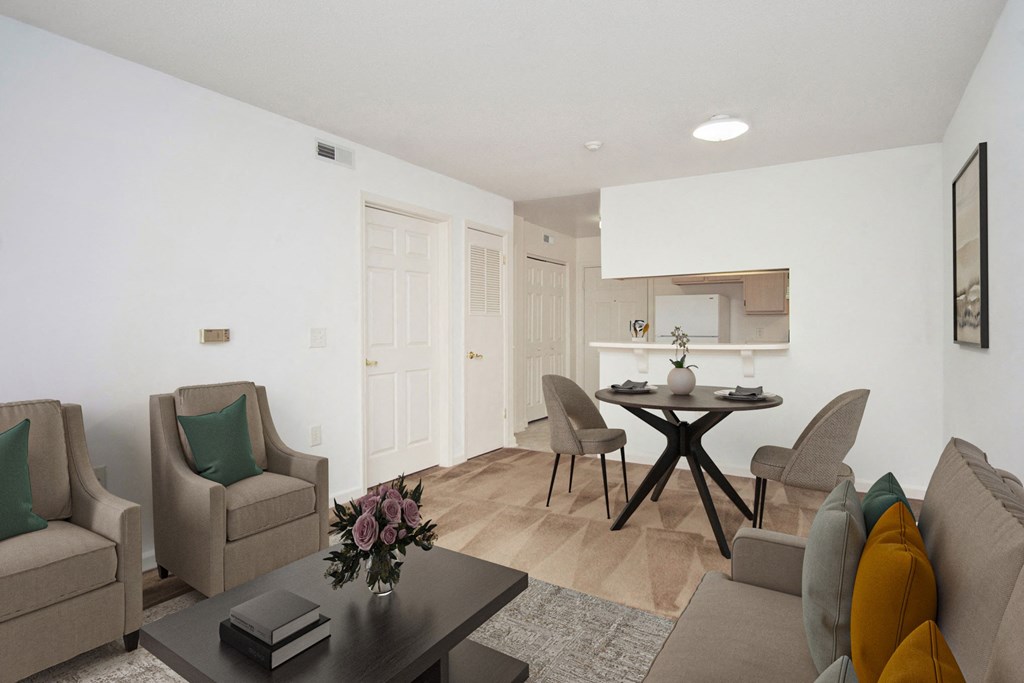 a living room and dining room with a table and chairs