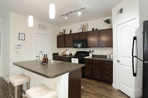 A kitchen with brown cabinets and a white refrigerator.
