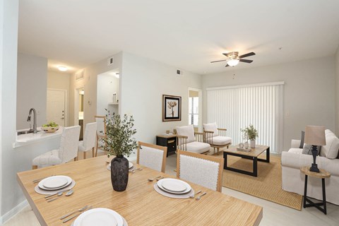 A dining room with a table set for four.