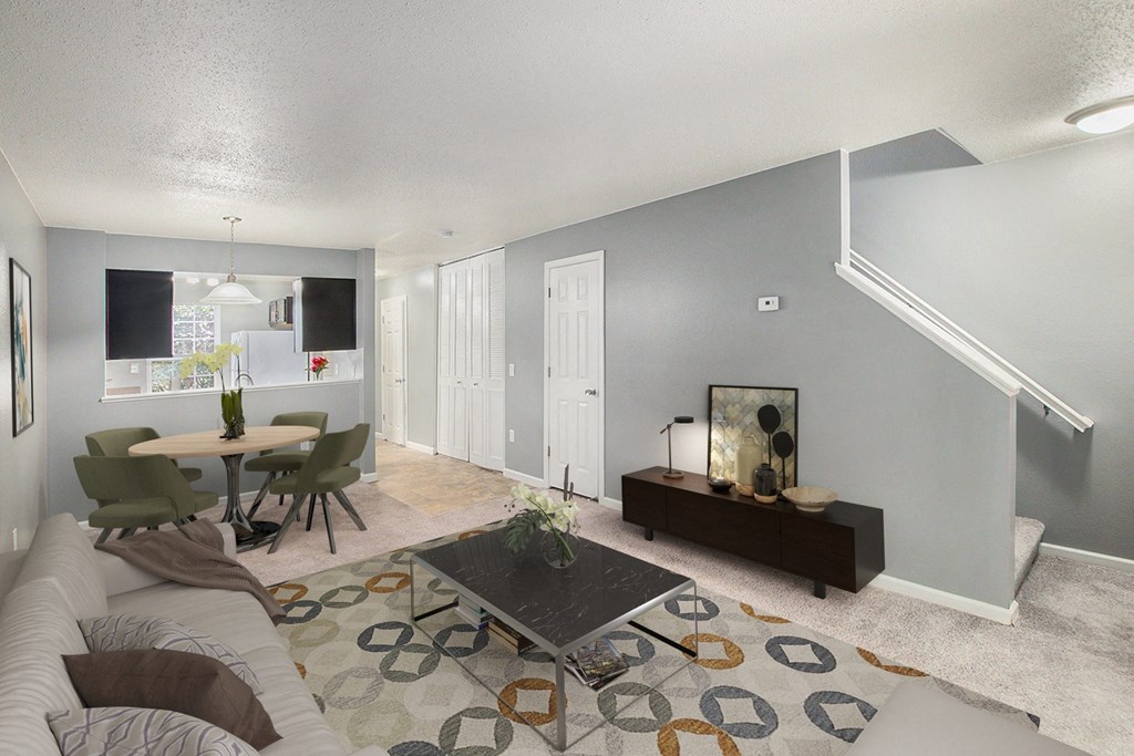 an open living room and dining room with a table and a couch