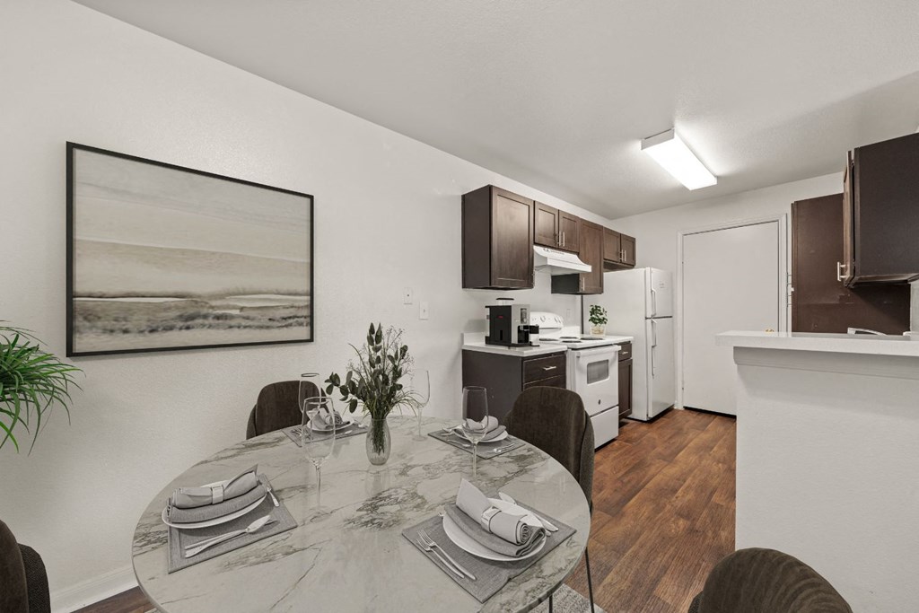 a kitchen and dining room with a table and chairs