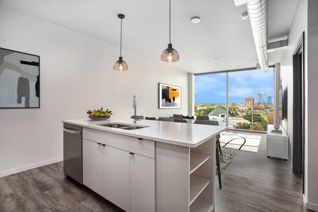 an open kitchen with an island and a view of the city