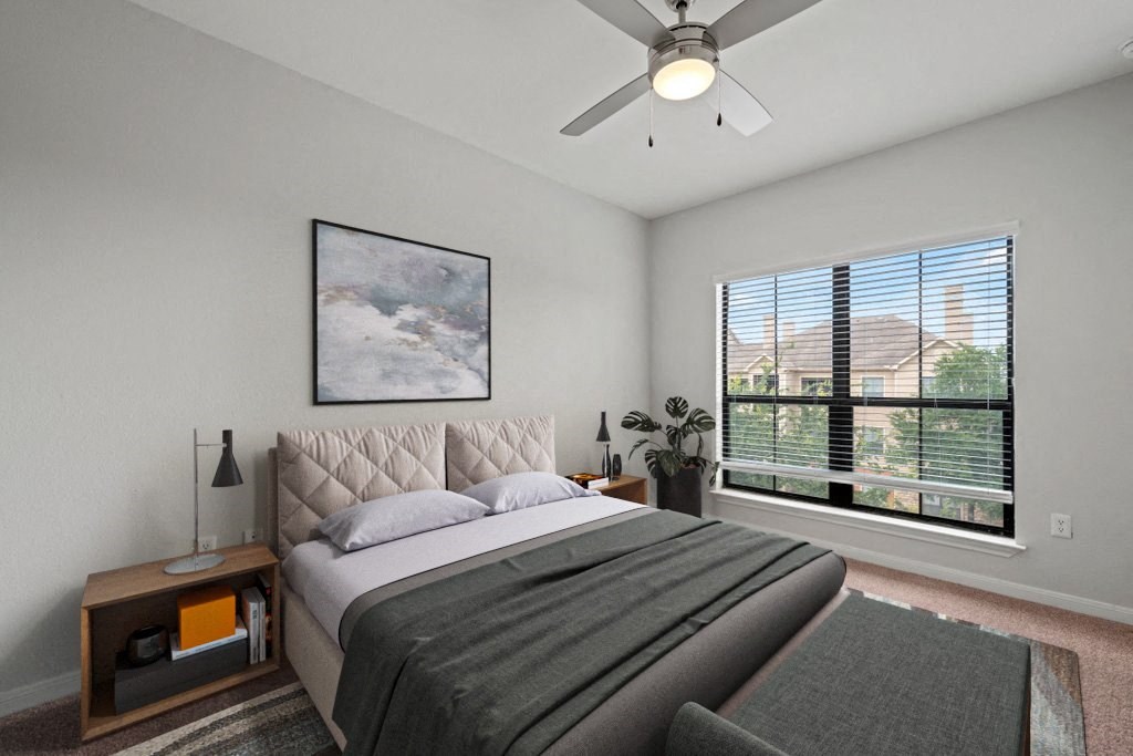 a bedroom with a large bed and a large window