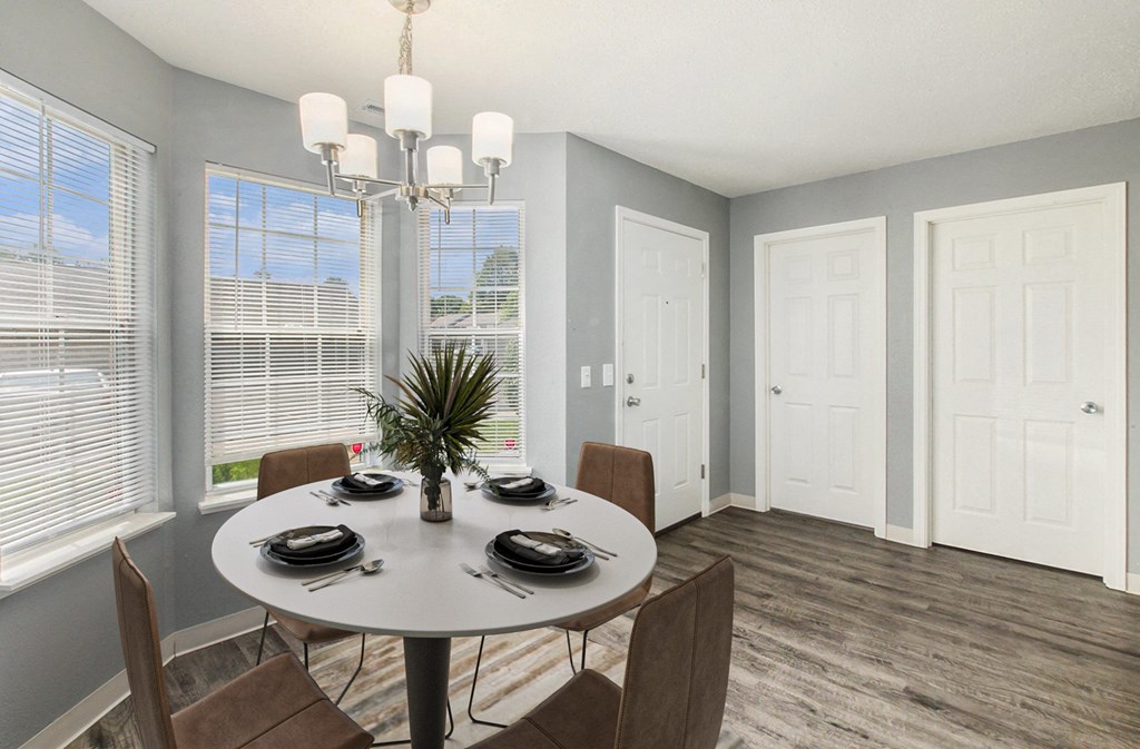 a dining room with a table and chairs and a chandelier