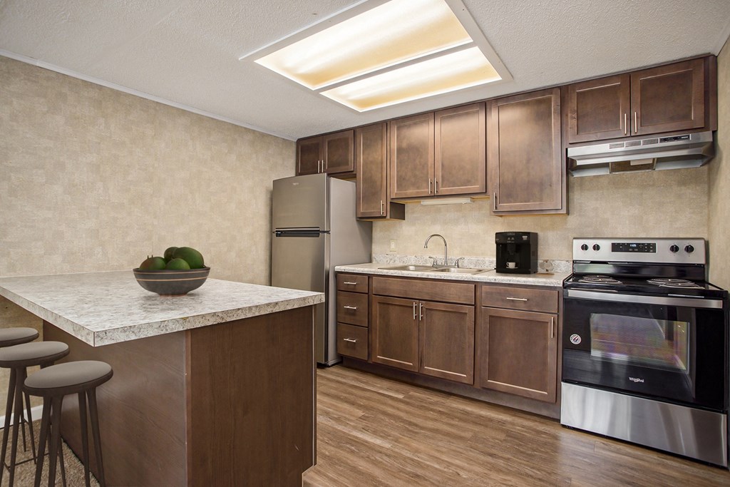 a kitchen with stainless steel appliances and wooden cabinets