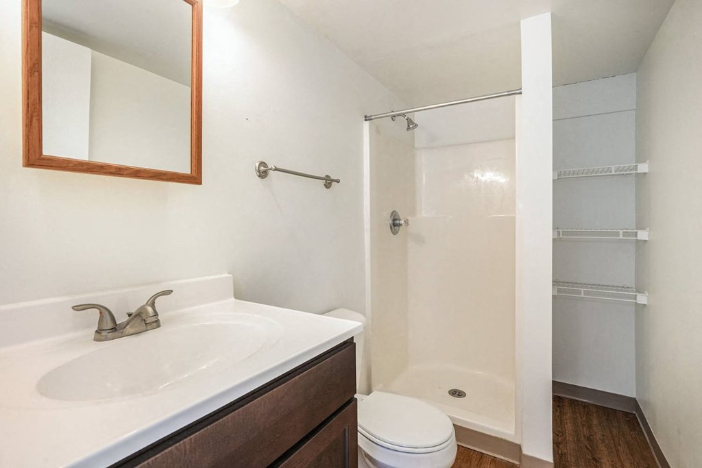 a bathroom with a sink toilet and shower