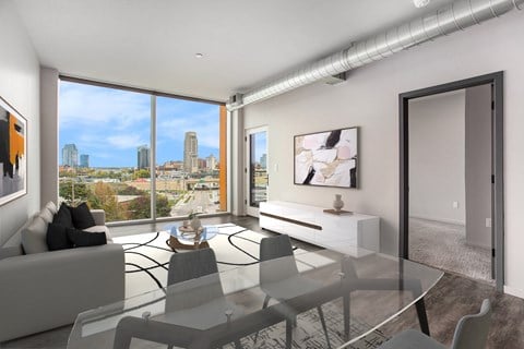 an open living room with a view of the city