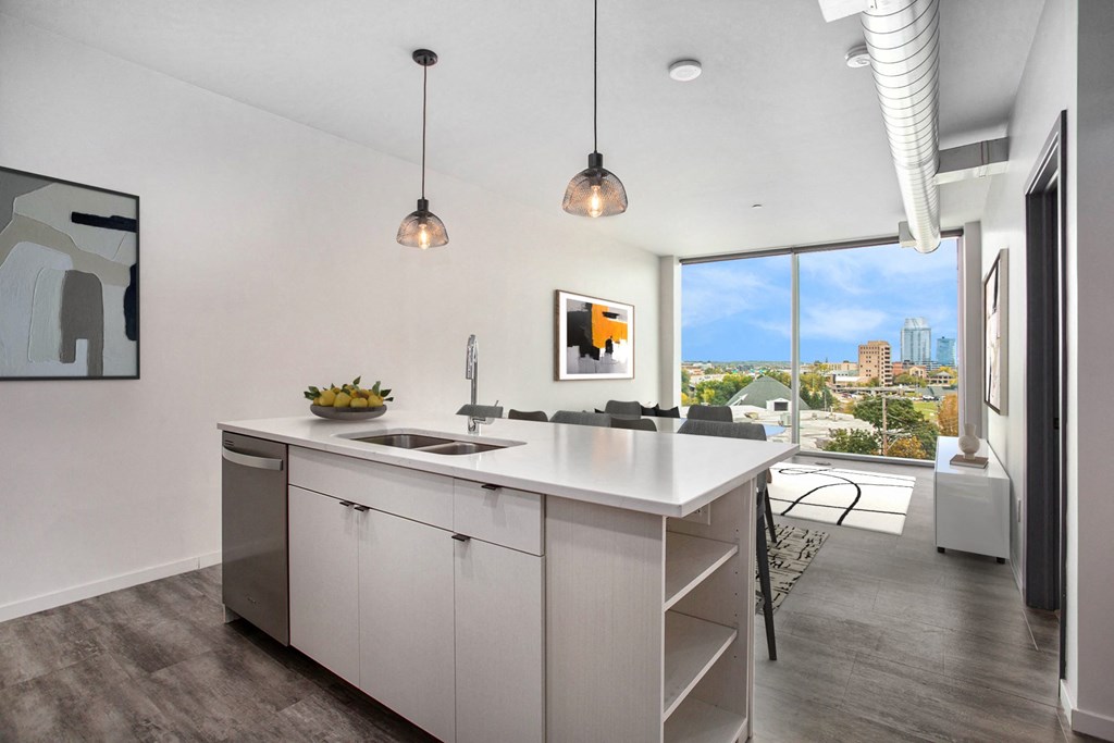 an open kitchen with an island and a view of the city
