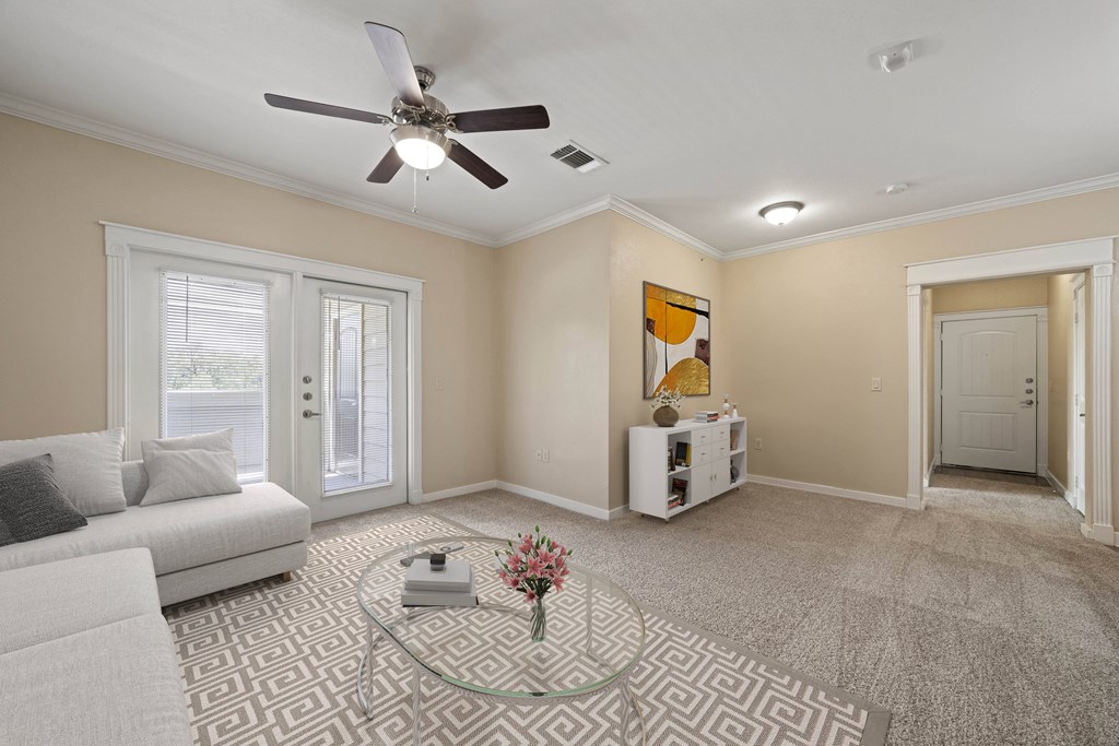 a living room with a couch and a ceiling fan