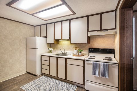 a small kitchen with white appliances and white cabinets