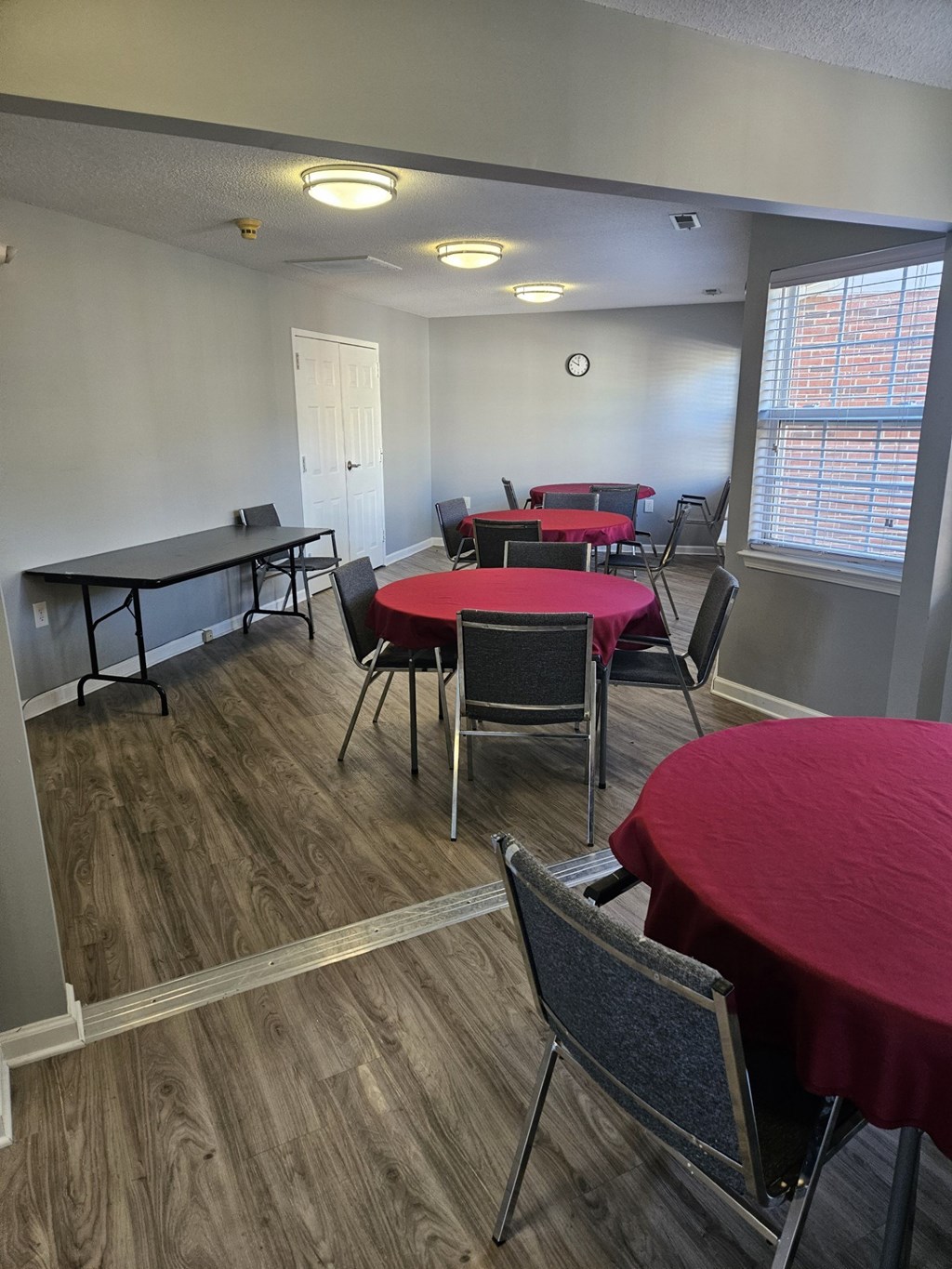 A room with tables and chairs set up for a meeting or event.