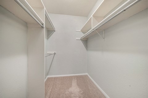 a spacious walk in closet at the oxford at estonia apartments in san antonio