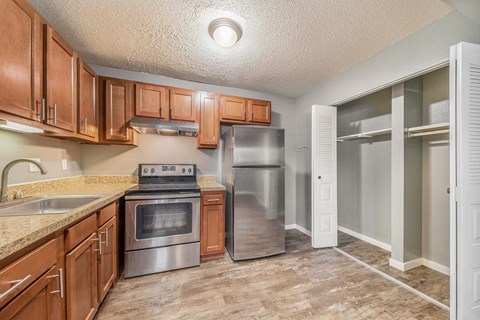 a kitchen with stainless steel appliances and wooden cabinets