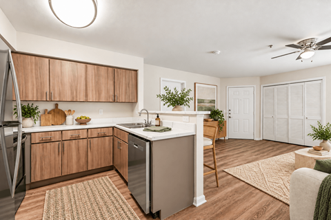 A kitchen with wooden cabinets and a white countertop.