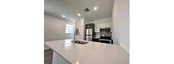 a kitchen with a large counter top and a sink
