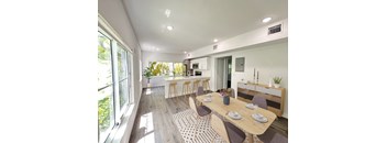 a dining room and kitchen with a table and chairs