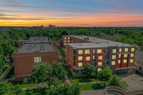 A sunset view of a campus with buildings and trees.