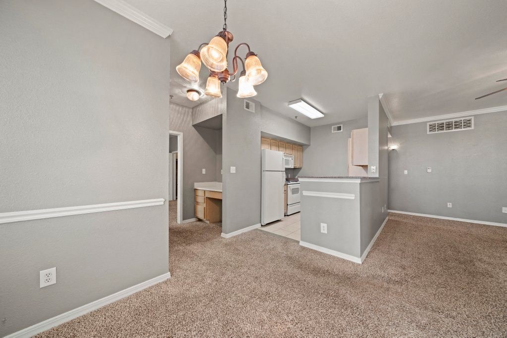 the spacious living room and kitchen in a new home