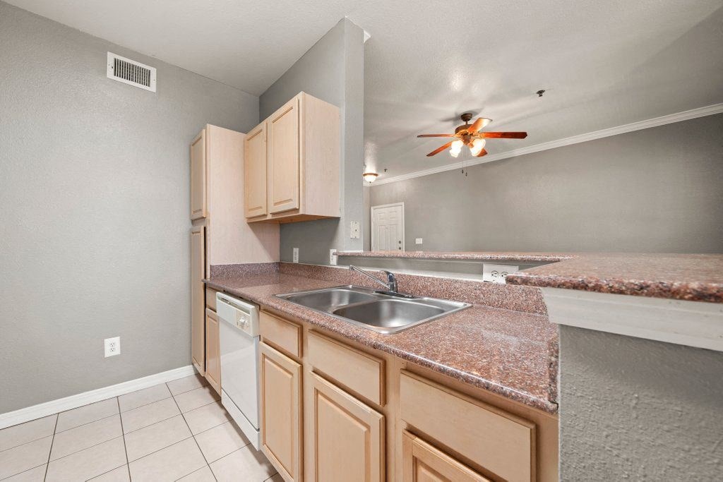 a kitchen with granite counter tops and a sink