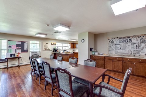 A dining room with a long table and chairs.