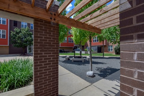 Wooden pergola overhangs a walkway in th