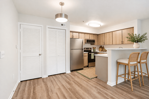 A kitchen with wooden floors and white walls.