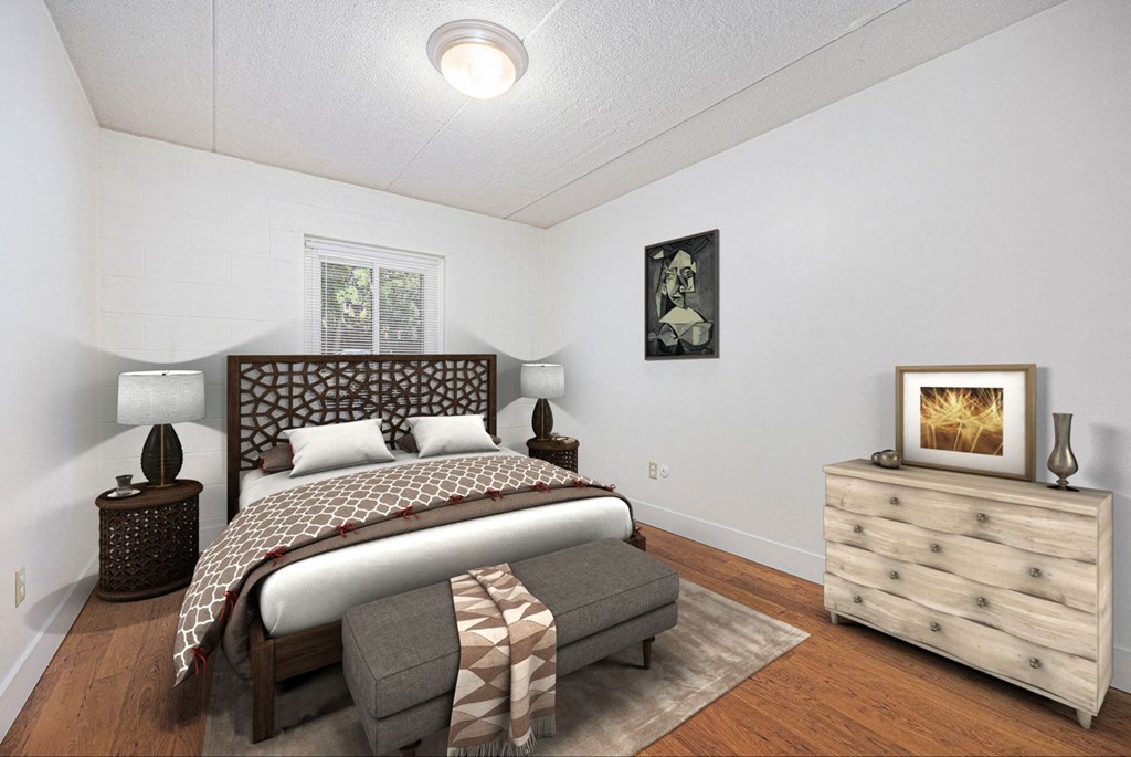 a bedroom with a bed and a dresser and a window