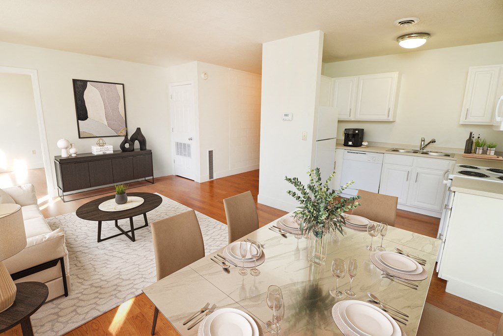 a living room and dining room with a table and chairs