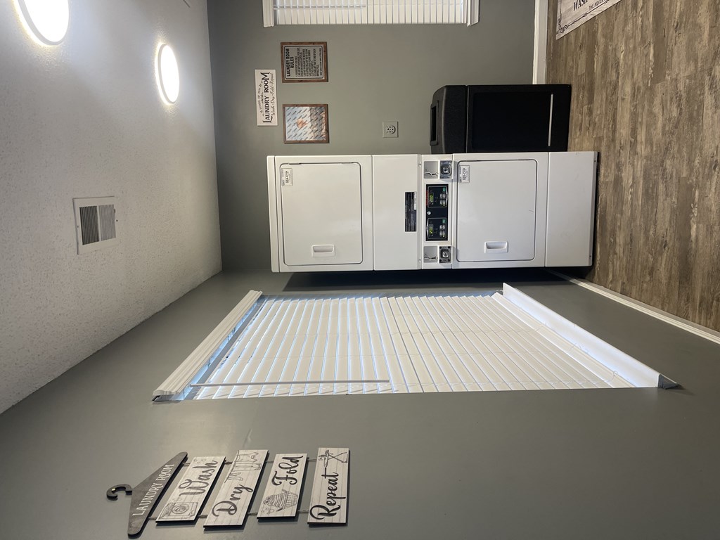 A white appliance in a room with a striped rug in front of it.