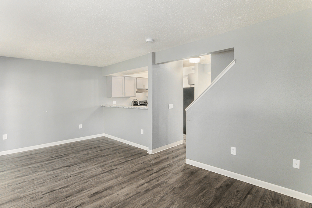 a bedroom with hardwood floors and grey walls
