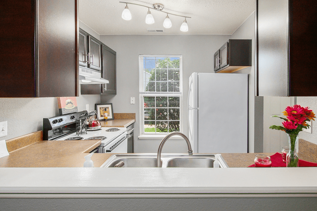 a kitchen with a sink and a refrigerator