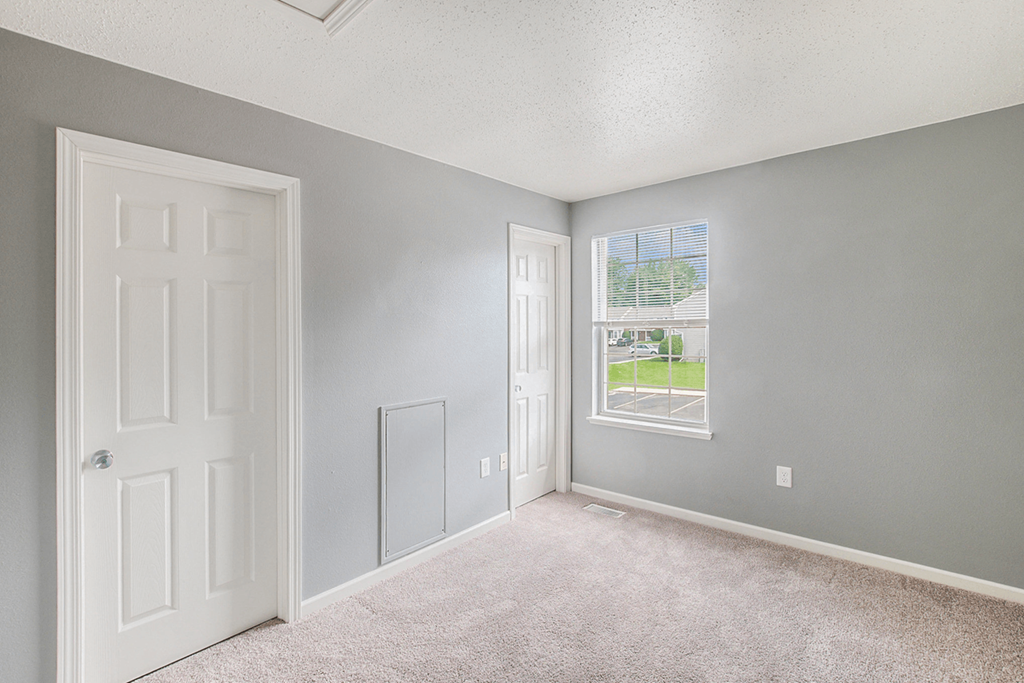 a bedroom with a door and a window