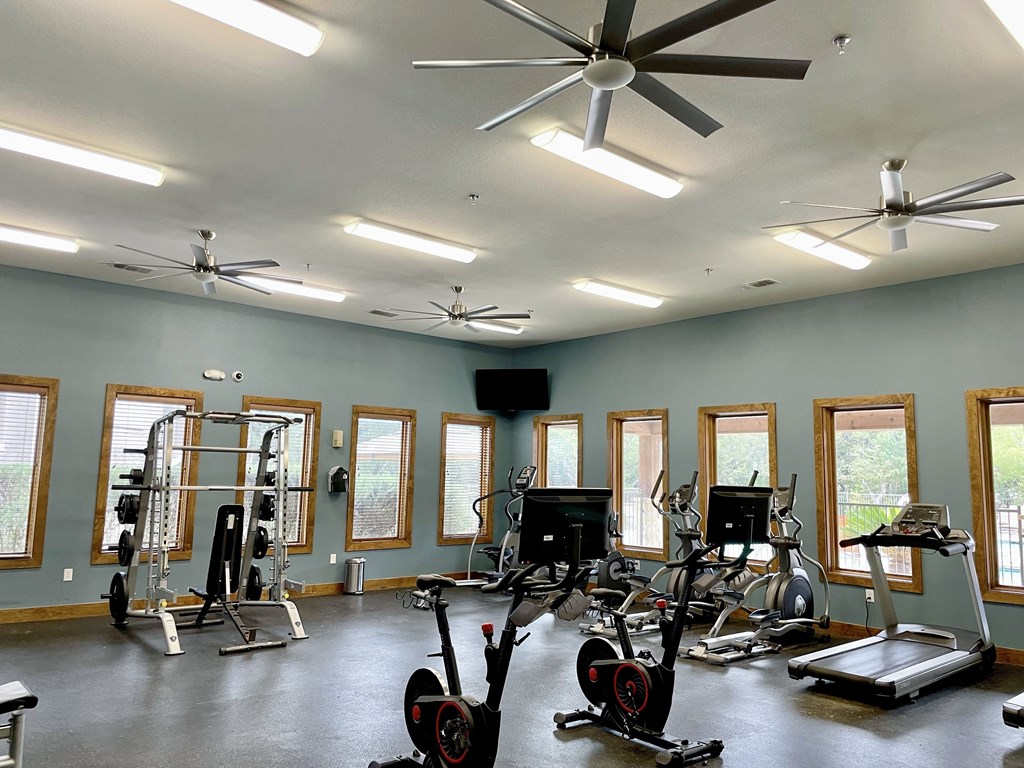 a room with a lot of exercise equipment in it