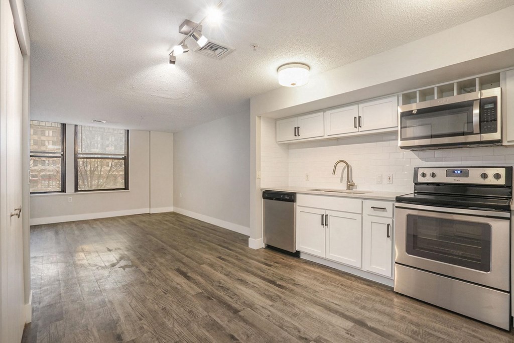 The Lofts Apartments in Grand Rapids, MI Open Concept Living Room with Hardwood Floors and Marble Countertop Kitchen